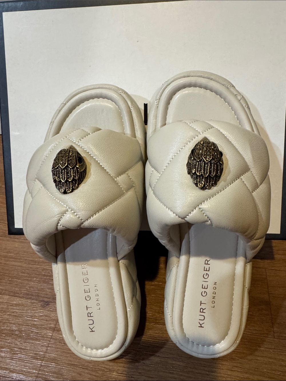 Kurt Geiger Cream Quilted Slide Mules with Gold Medallion